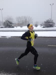 Colton at mile 17 with ice frozen in his hair, beard and gloves.